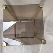 Square side table in metal and smoked glass.