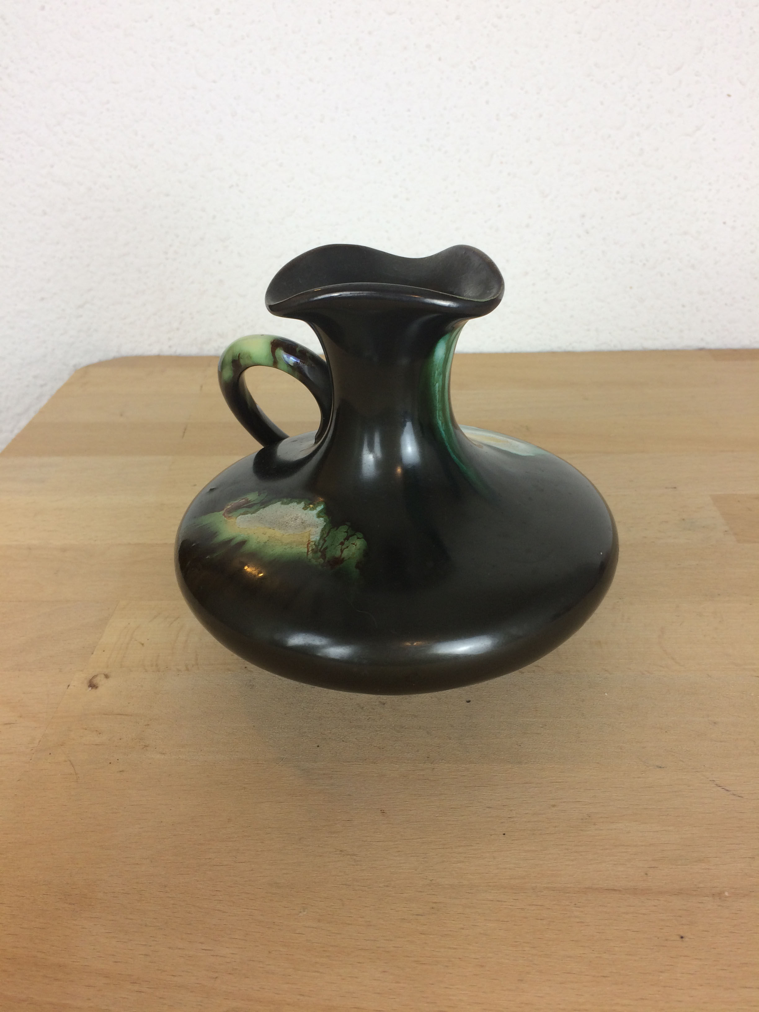 Thulin Belgium pitcher, black ceramic handle