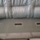 Three-seater sofa in green leather with a solid wood frame