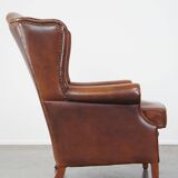 Fauteuil à oreilles en cuir de vachette cognac