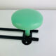 Wall-mounted coat rack with 2 green hooks from the 1950s.