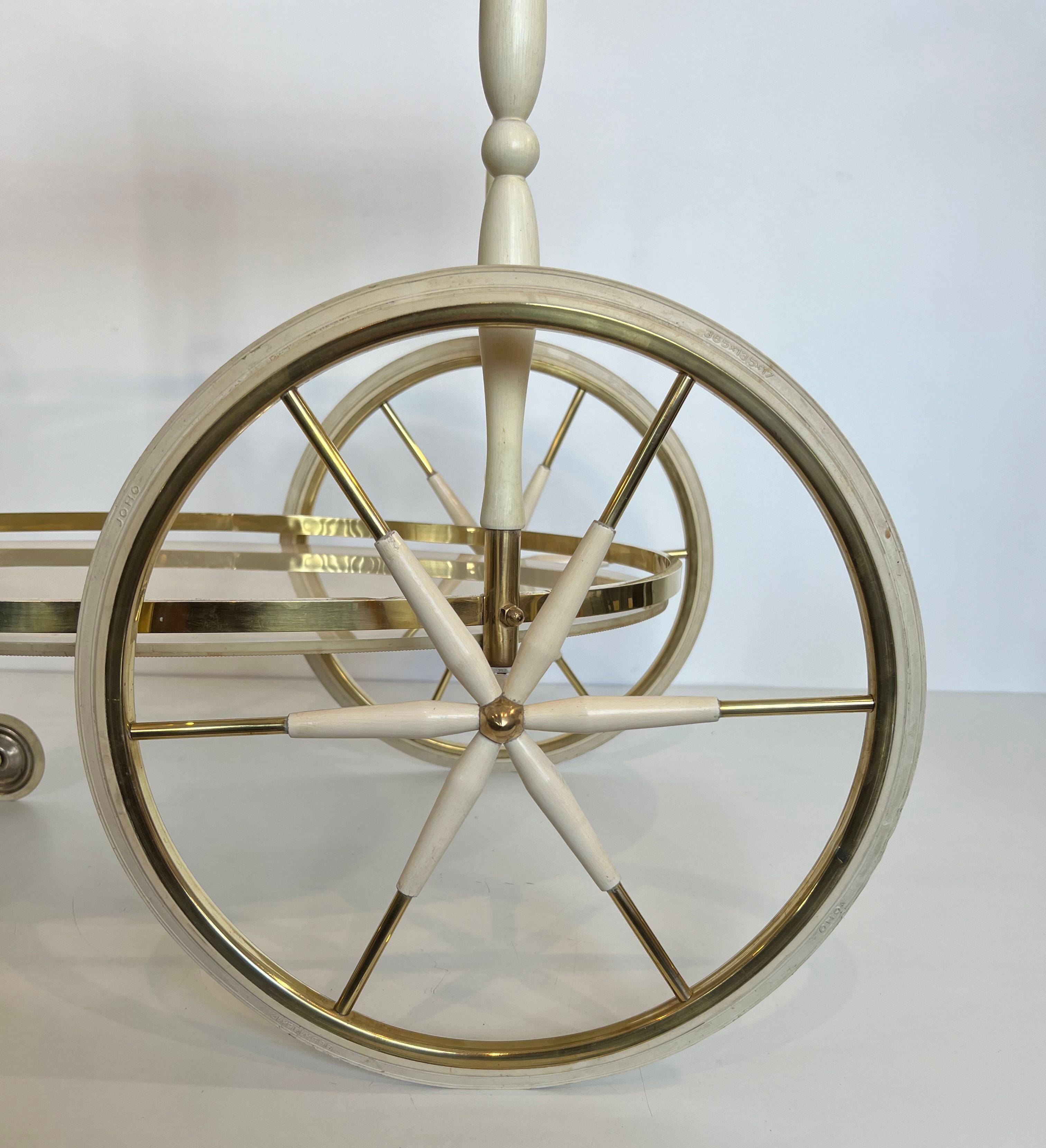 Italian oval rolling table in brass and lacquered wood.