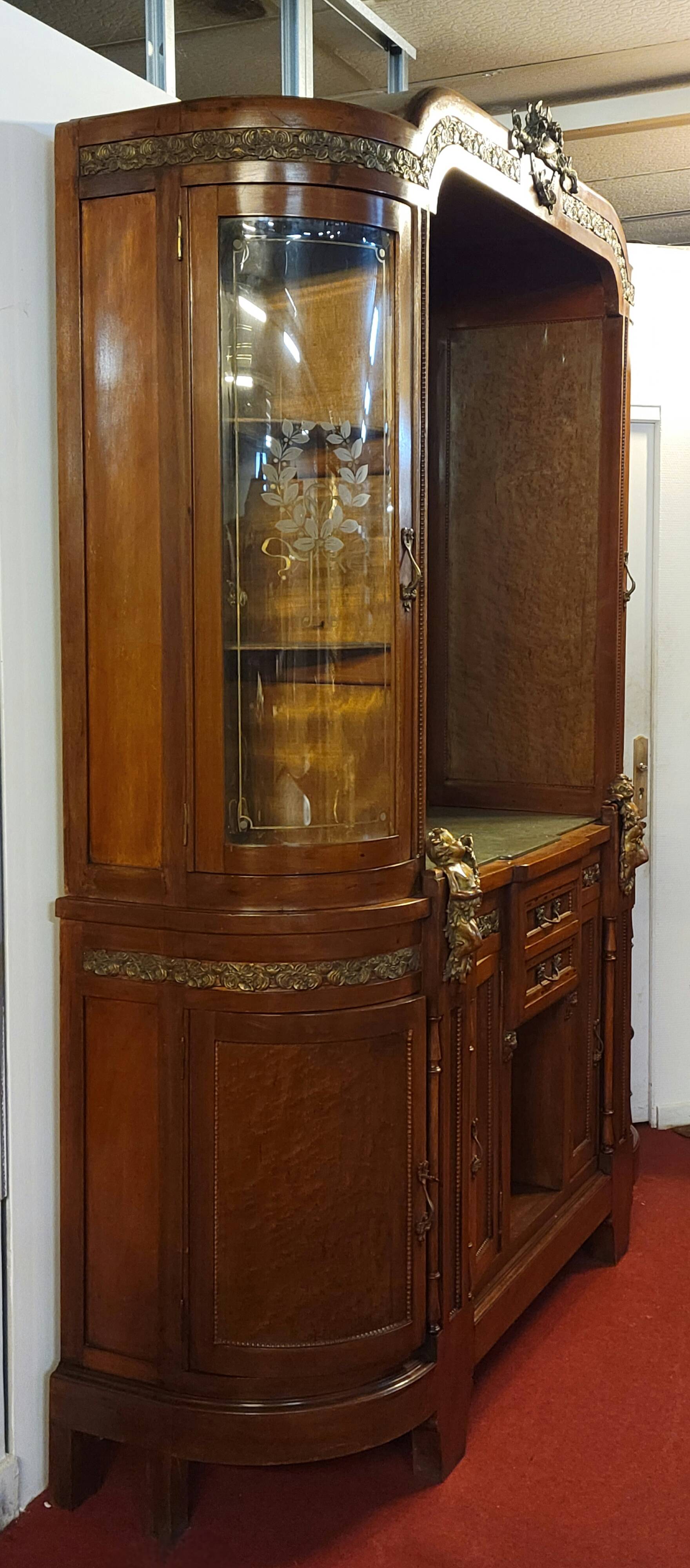 Empire style half-moon shaped mahogany bookcase with putti