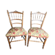 Two floral upholstered music chairs from the early 20th century.