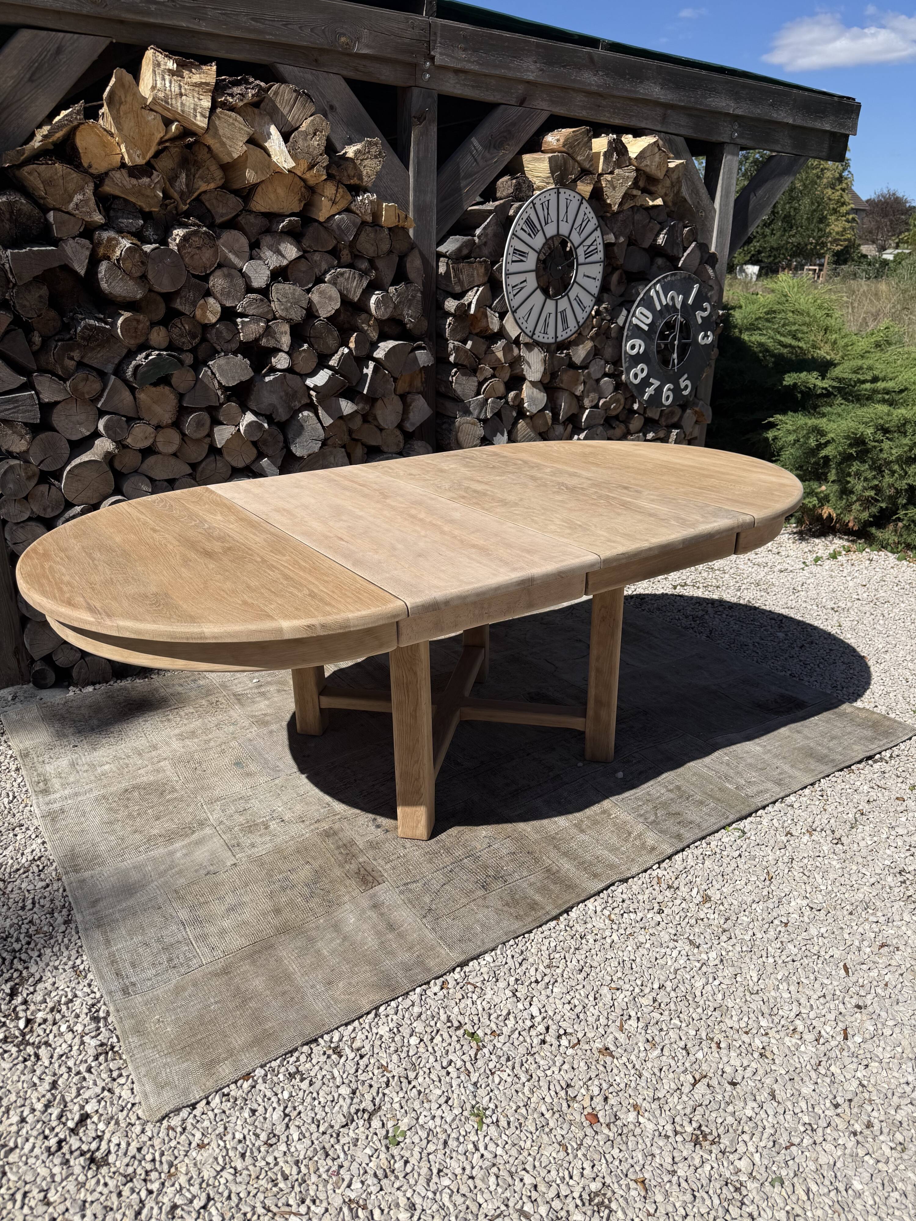 Round solid oak table with extensions, maximum 220cm.