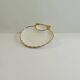 Shell-shaped porcelain pocket bowl from Queen’s Porcelain, with a gold rim.