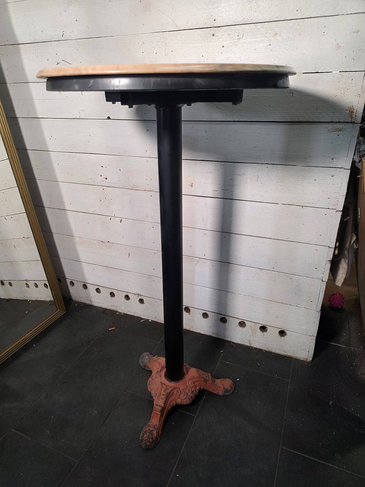 Bistro standing table with marble top and cast iron base.
