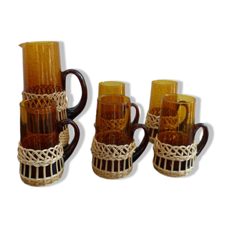 Fruit juice or vintage lemonade service in glass and wicker.