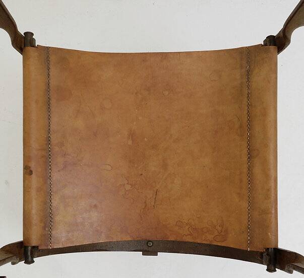 Curule armchair in wrought iron and leather