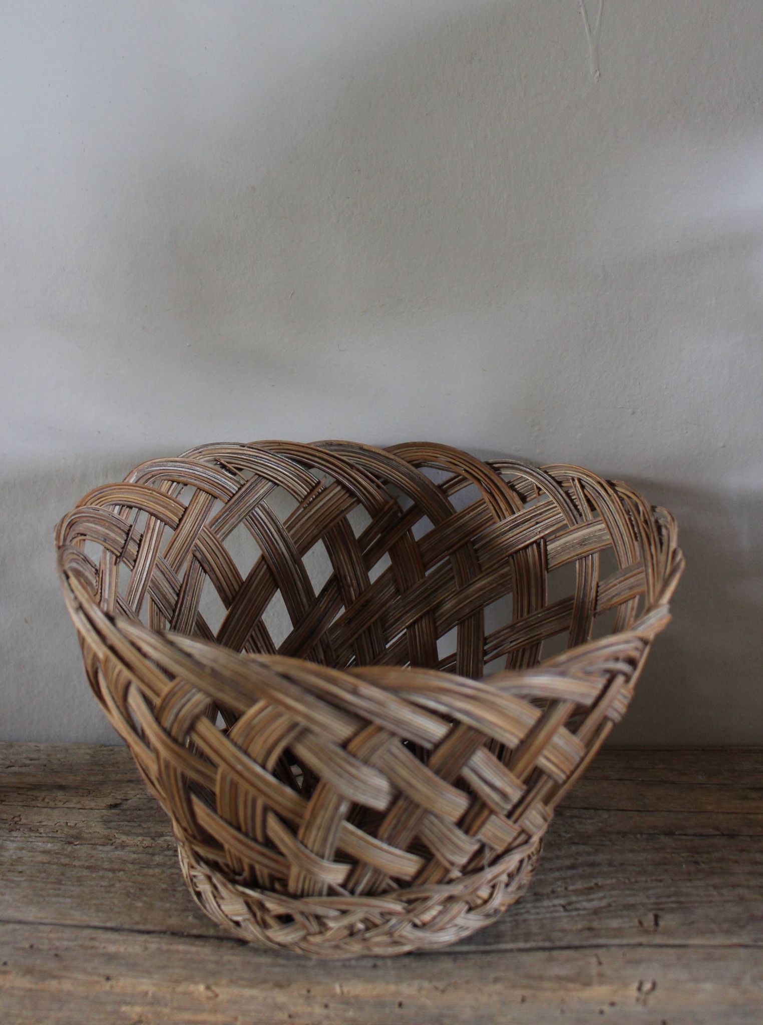 Vintage high round wicker basket with openwork.