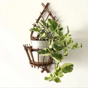 Wall-mounted plant holder in rattan