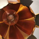 Hanging lamp in thin metal pieces, copper colored and black with prisms.
