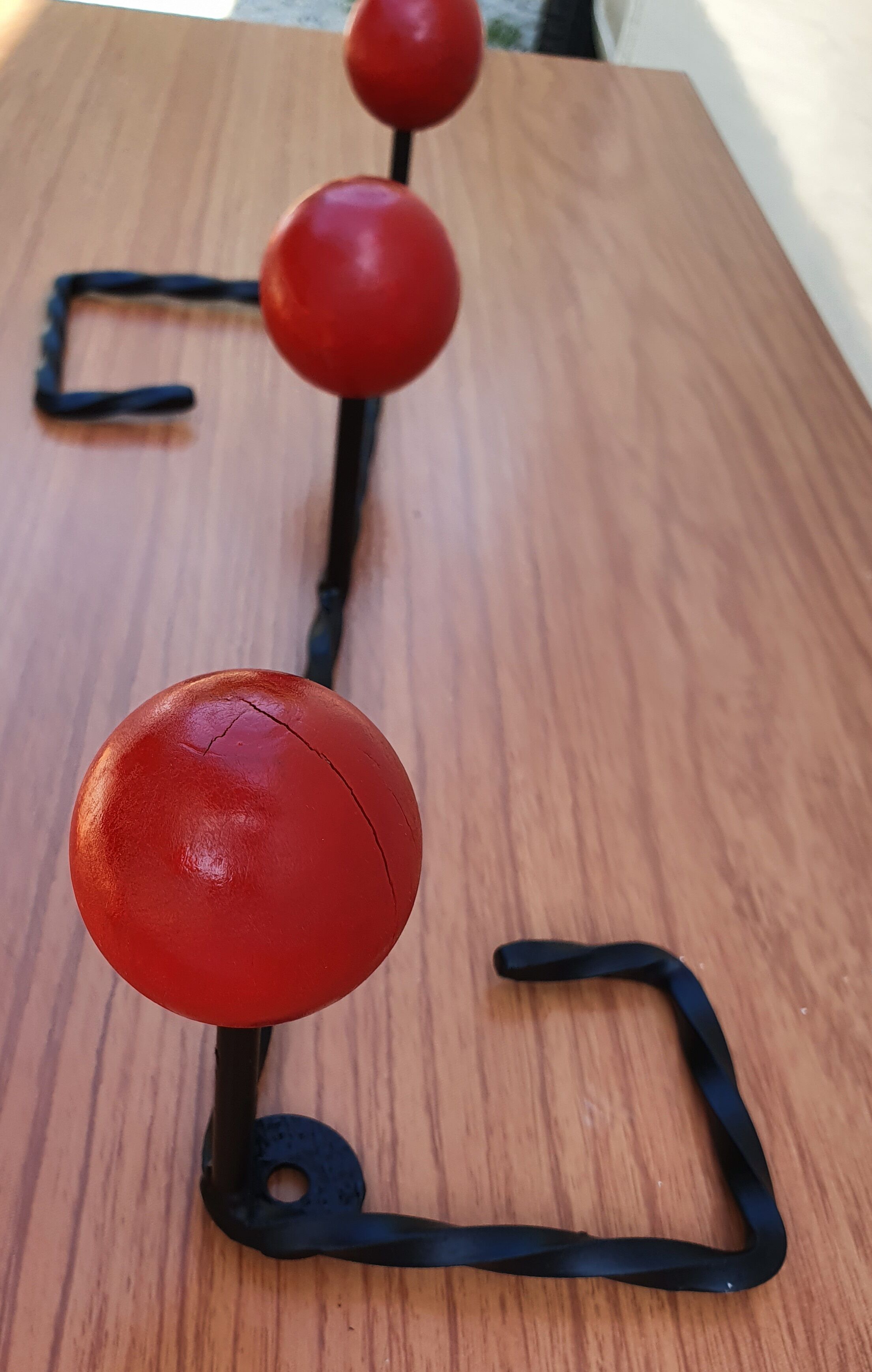 Coat rack wrought iron and red wooden balls