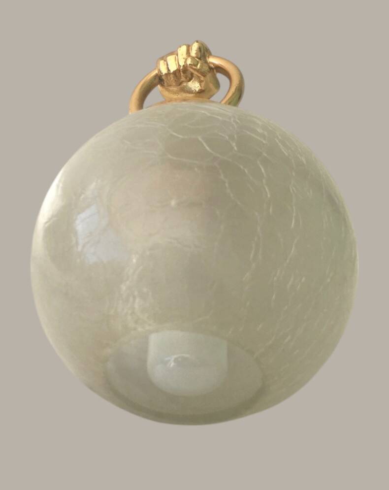 Wall light with golden hand and glass globe