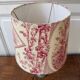 Empire style lamp with a toile de Jouy shade.