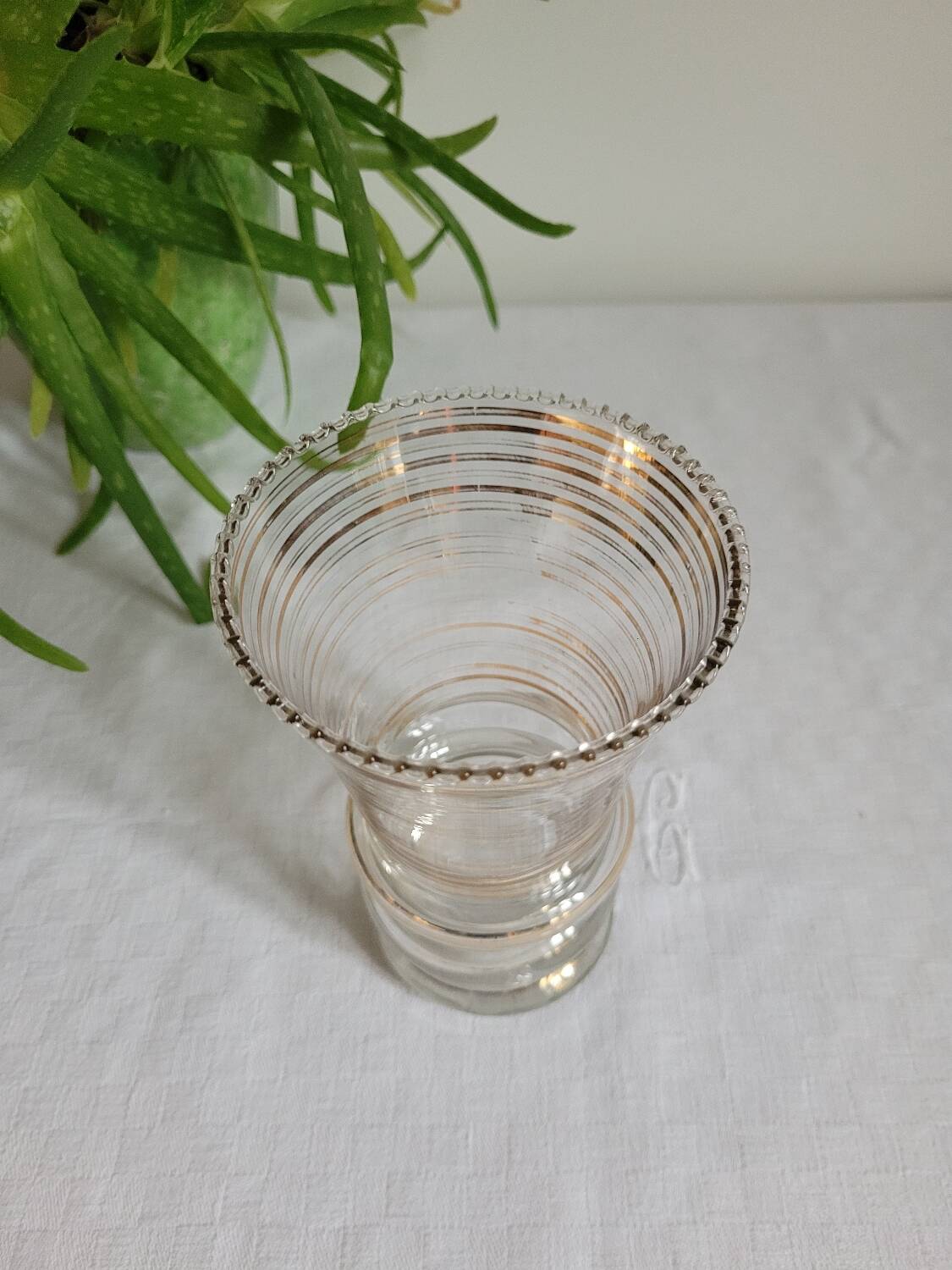 Flared glass vase with gold trim