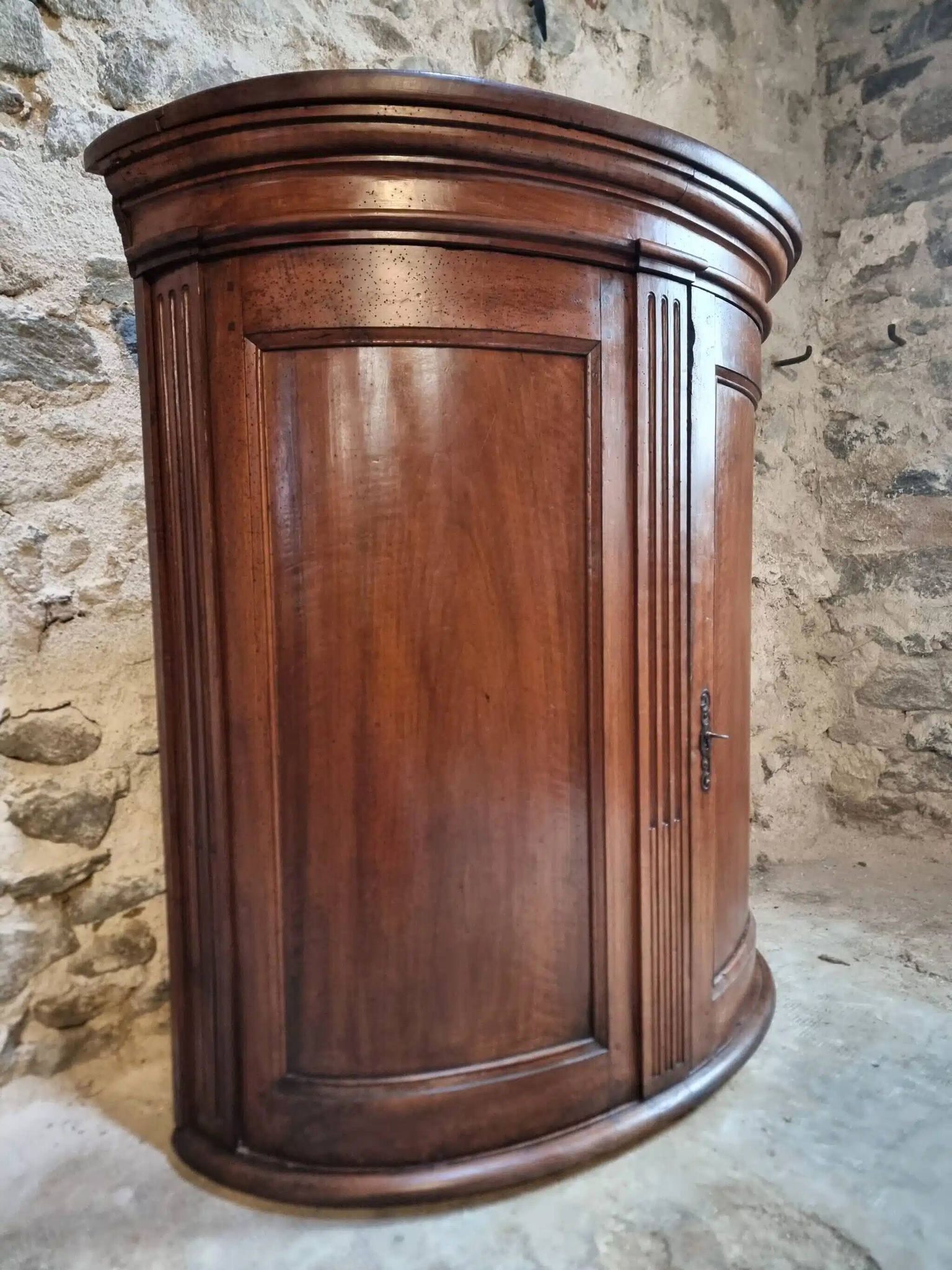 Antique demi-lune cabinet in walnut, late 18th century, French château.