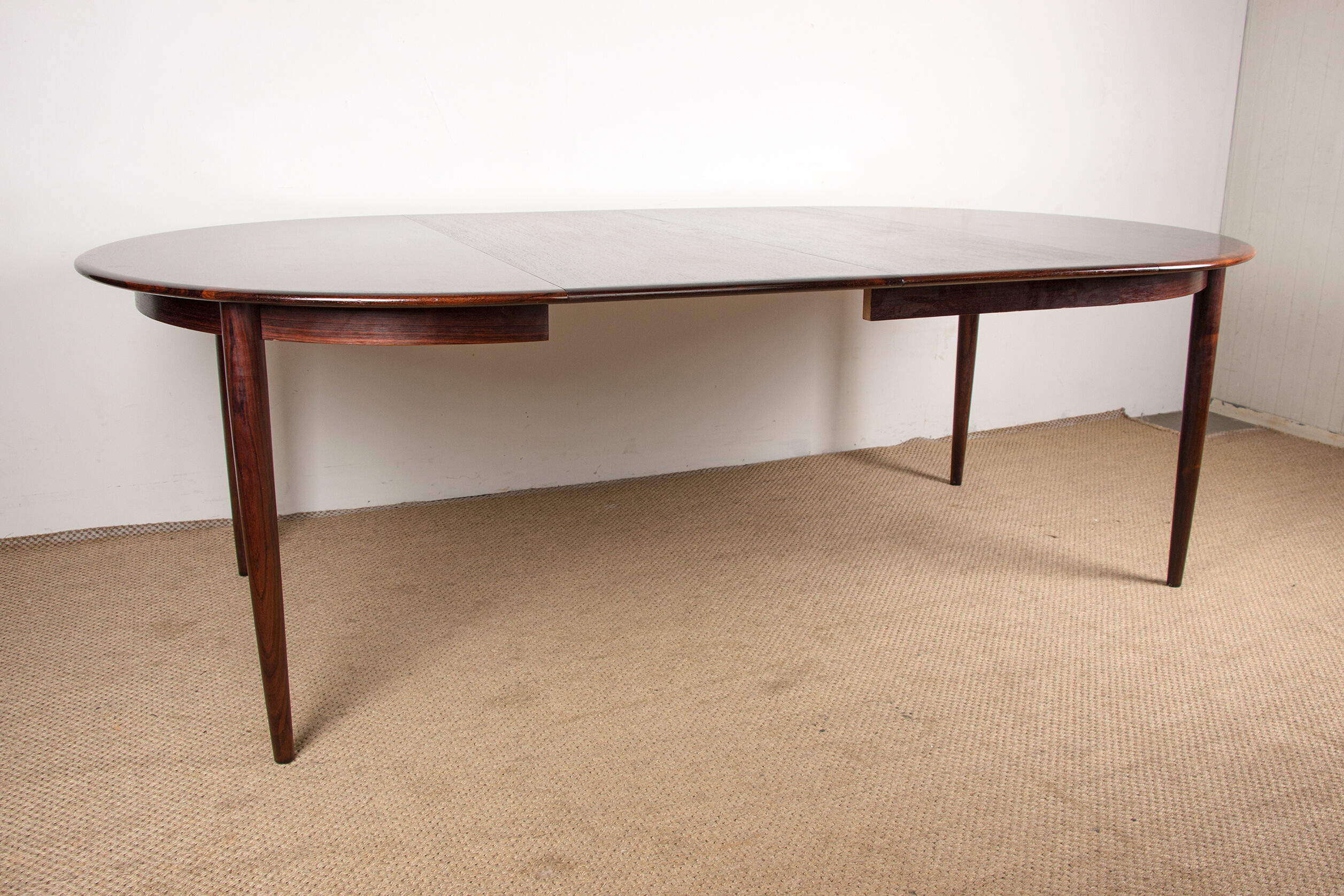Danish extendable dining table in Rio Rosewood model 55 by Arne Vodder for Sibast 1958.