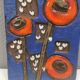 Ceramic relief in attractive blue with a motif of white/red flowers.