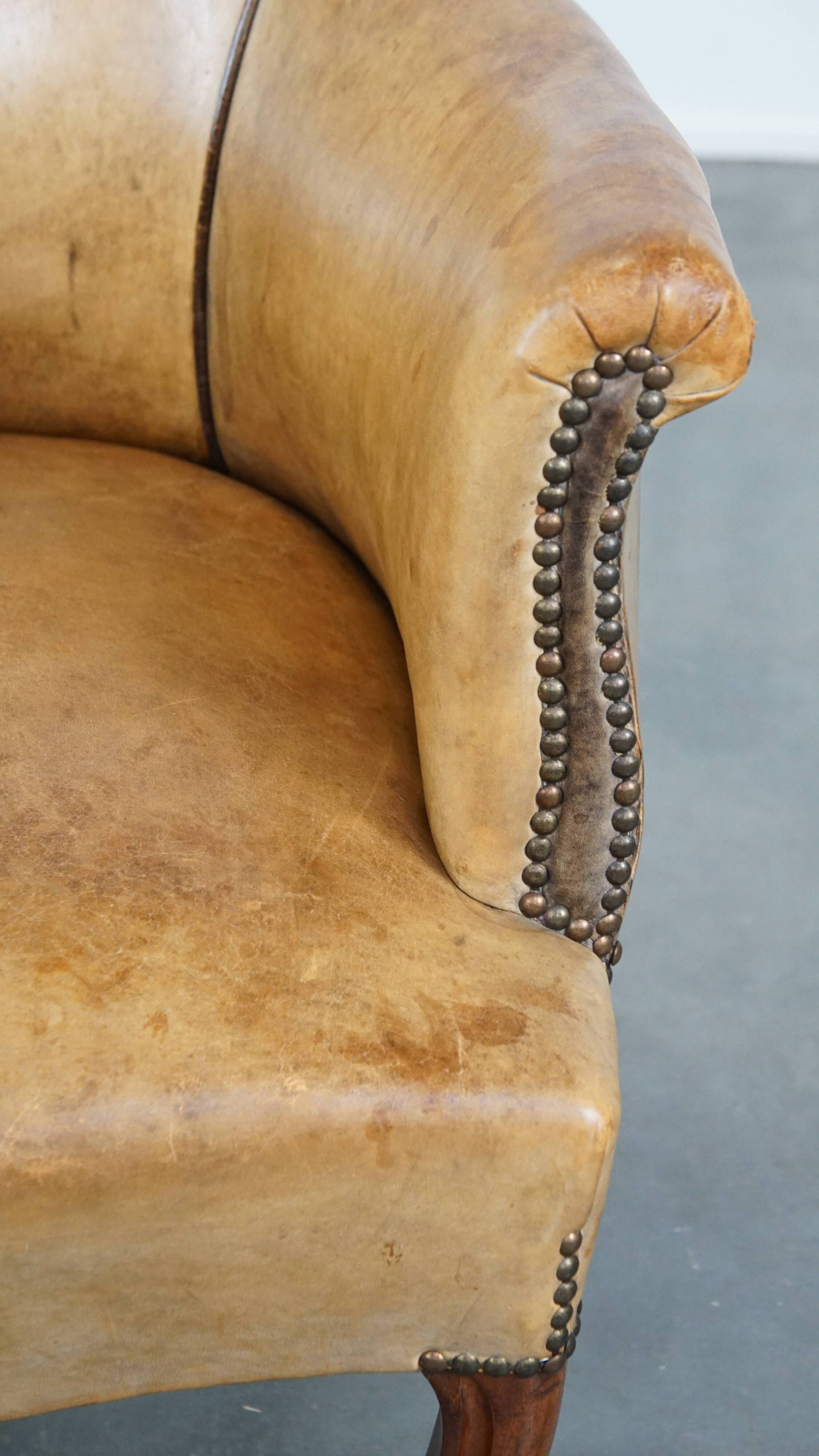 Antique sheep leather club chair/armchair on wheels