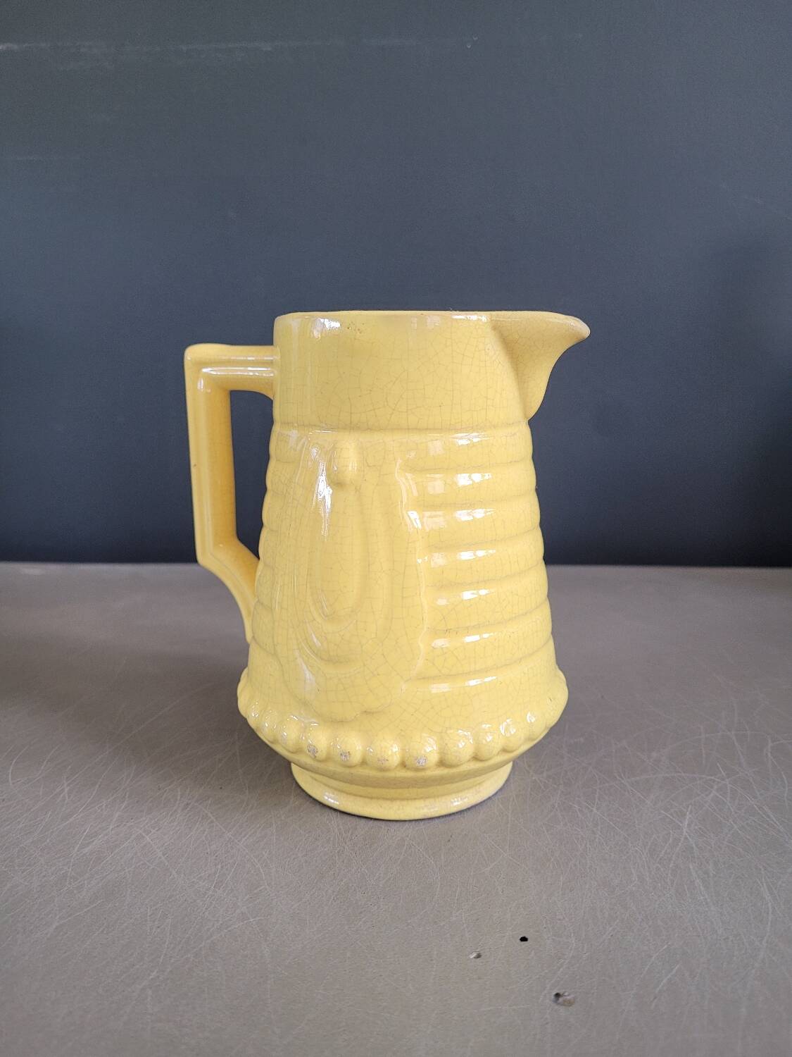 Yellow milk jug with reliefs