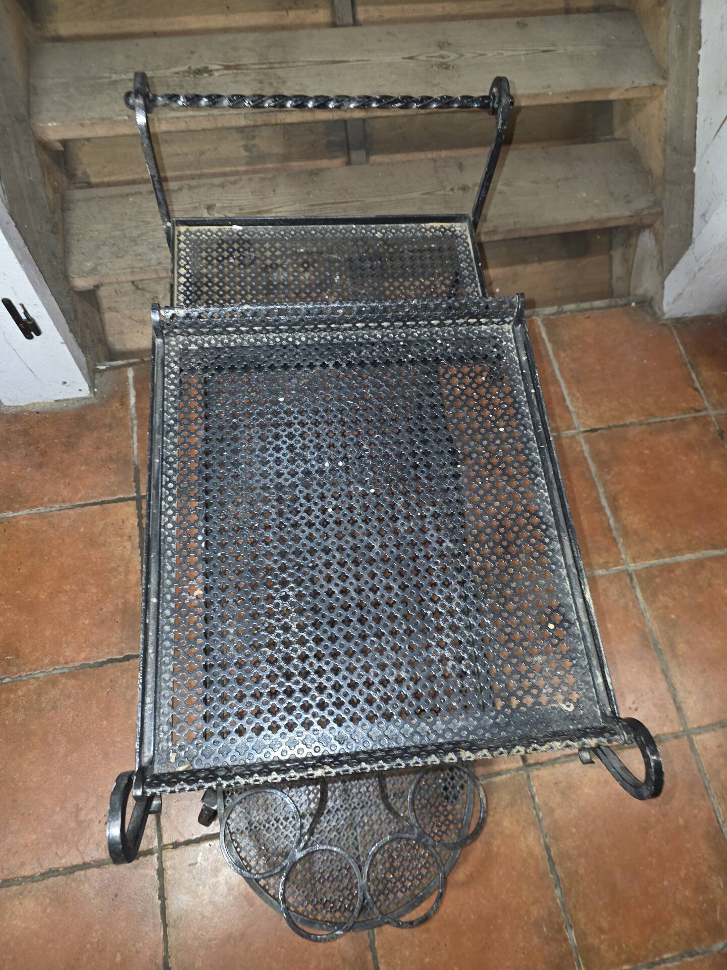 Perforated wrought iron rolling dessert trolley