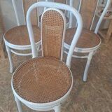 4 white rattan and cane chairs