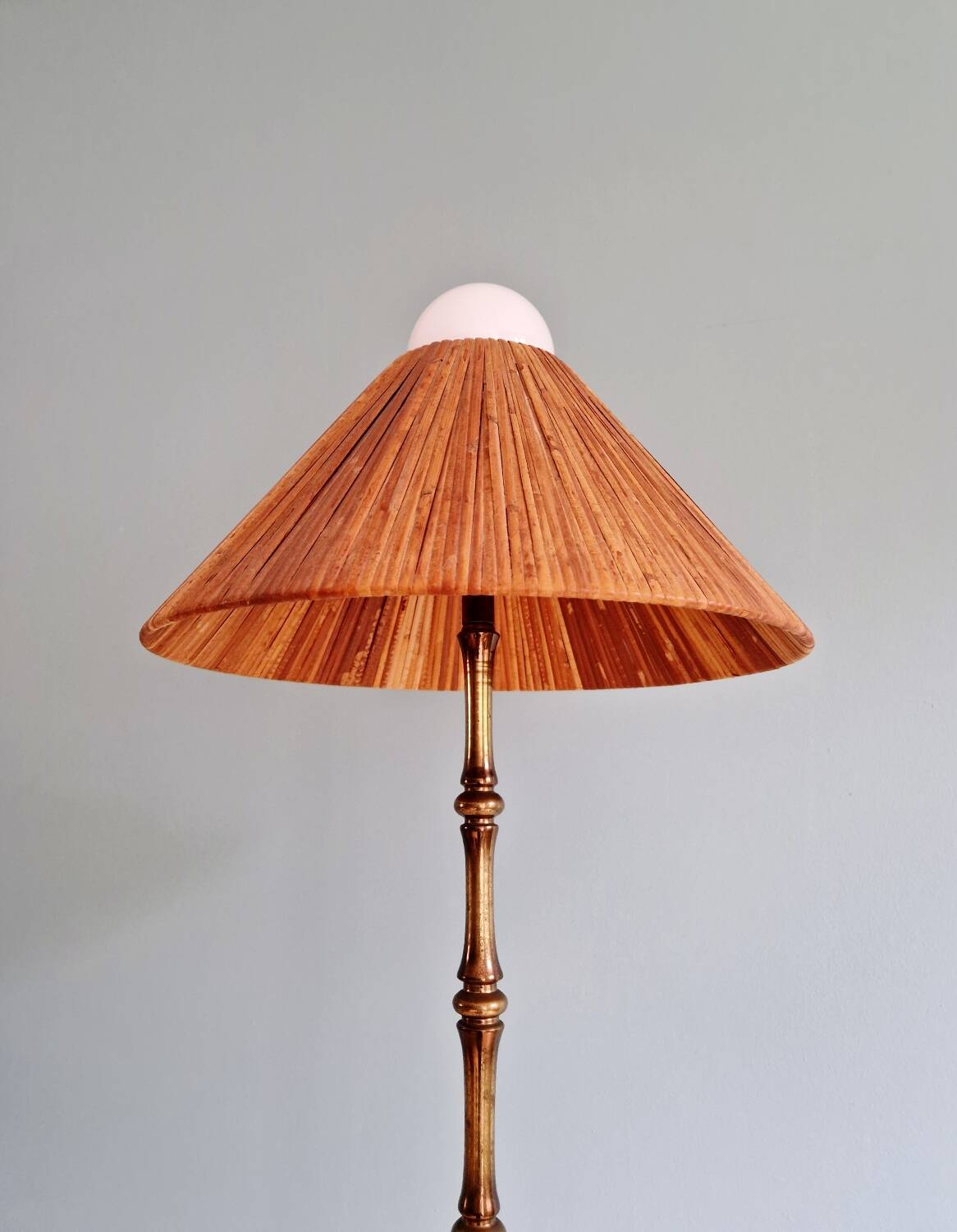 Brass floor lamp with rattan shade, 1950s-60s.