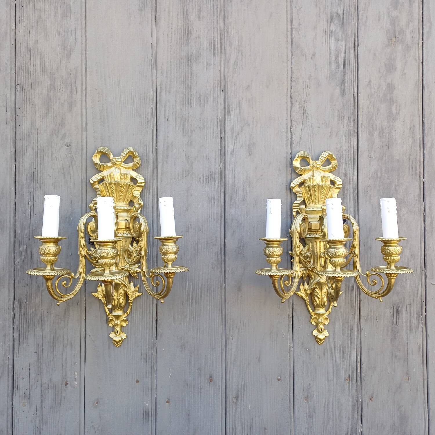 Pair of antique bronze wall sconces from the Napoleonic III era in the Louis XVI style.