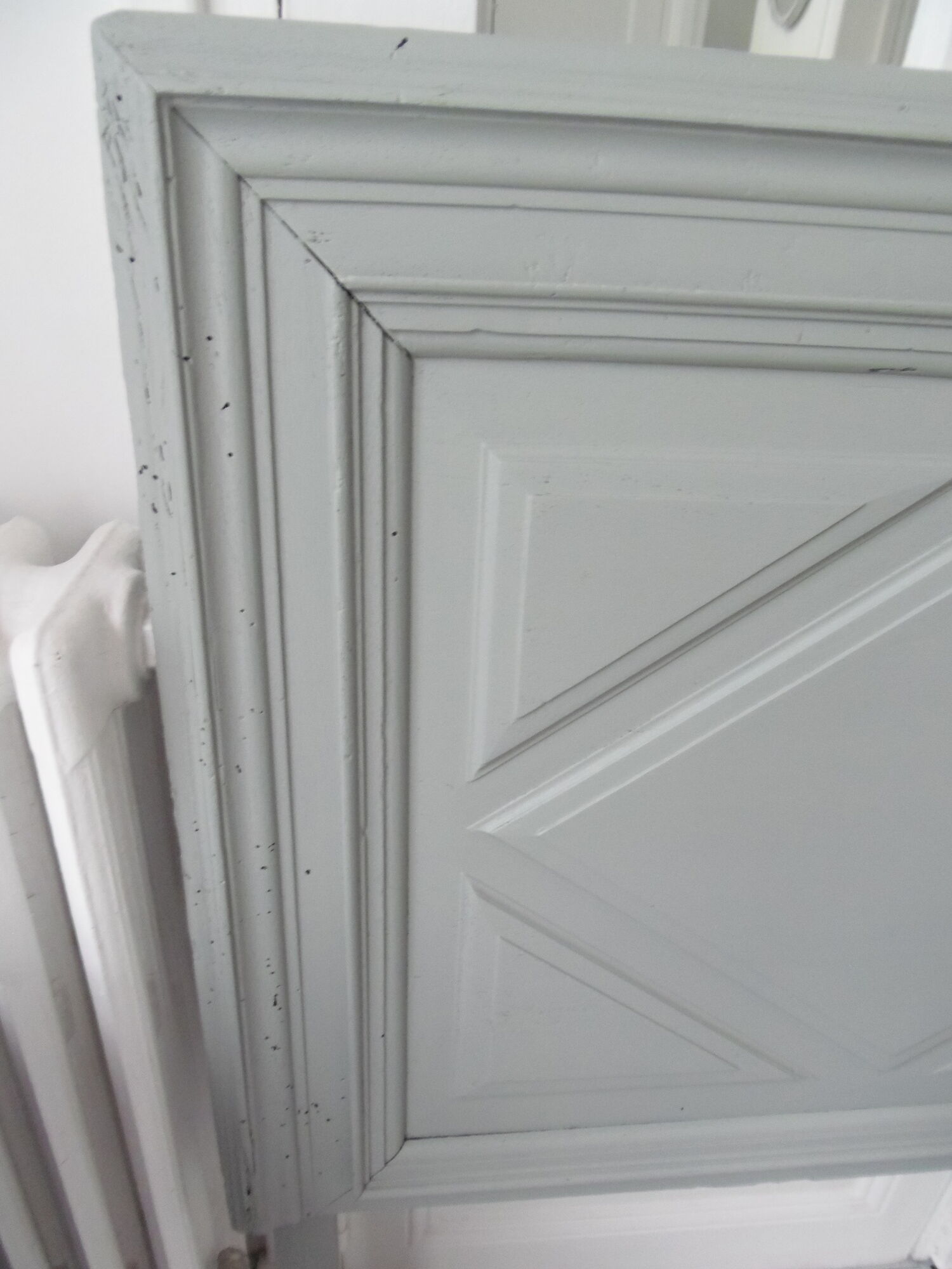 Headboard made with an old walnut door, re-enchanted in gray green waxed finish,