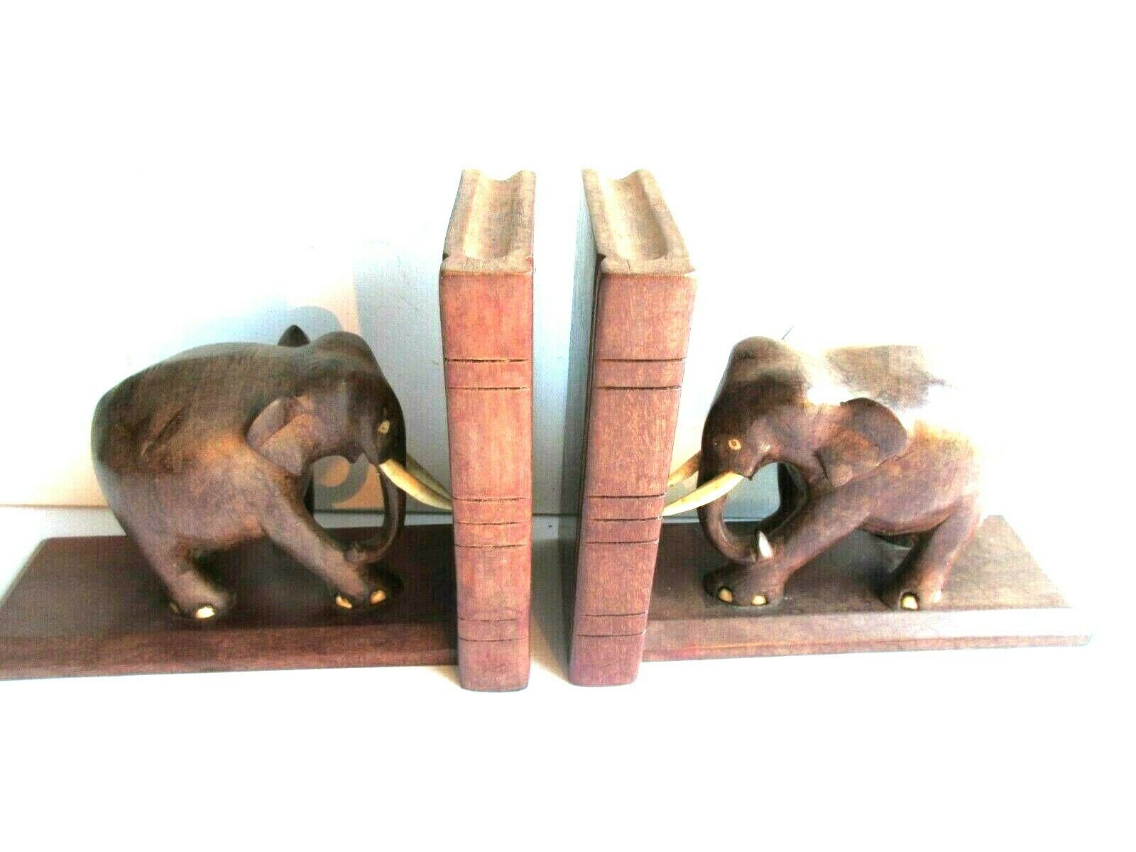 Art Deco bookends wooden elephants and bones on wooden terrace, book shape