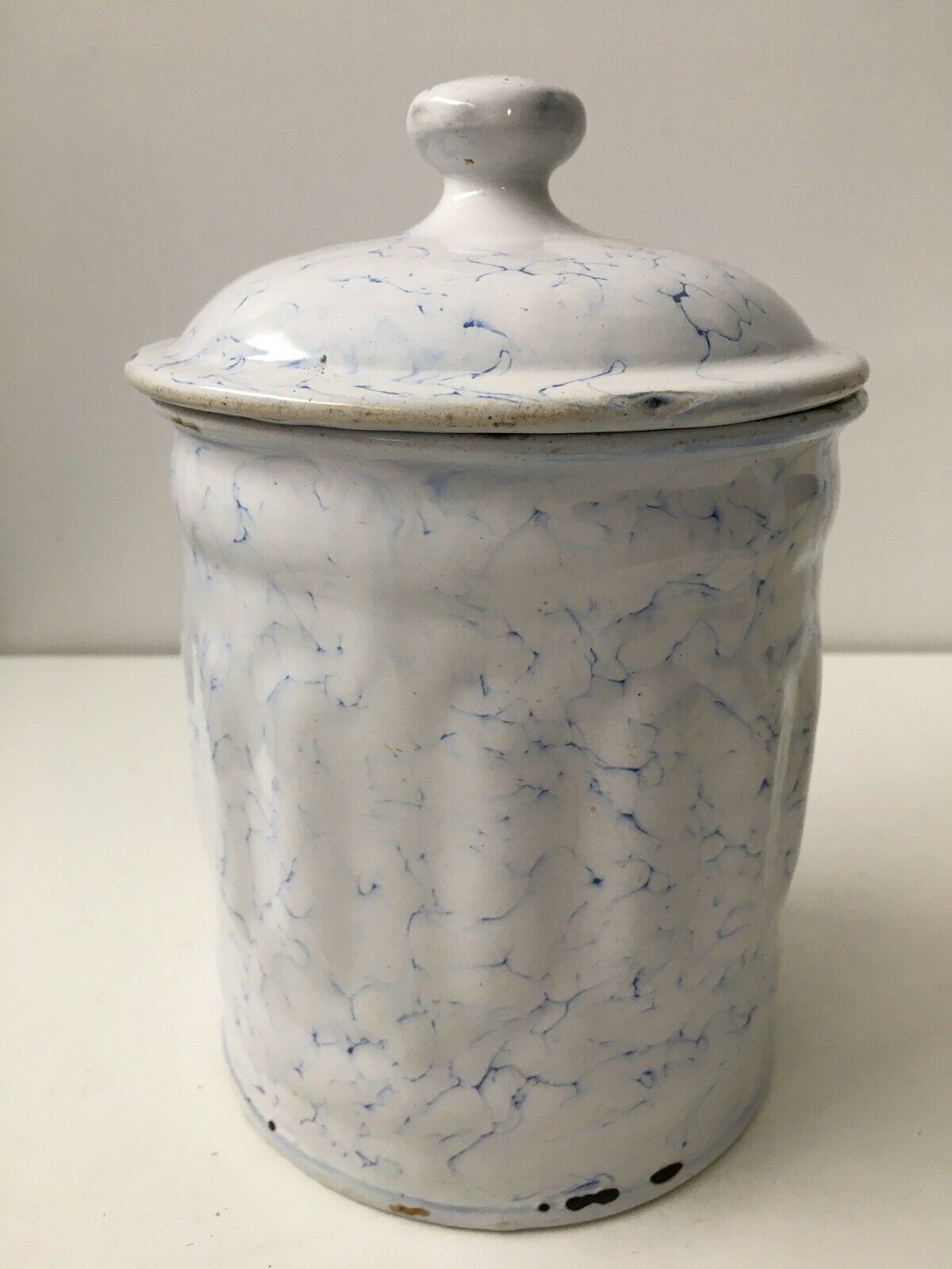 Vintage coffee pot in white enamelled iron and blue retro kitchen decoration