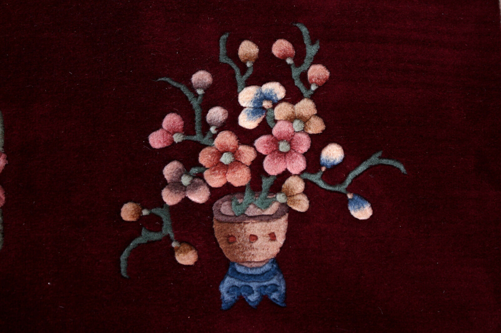 China wool fringed rug with floral pattern on deep plum background 393x274cm