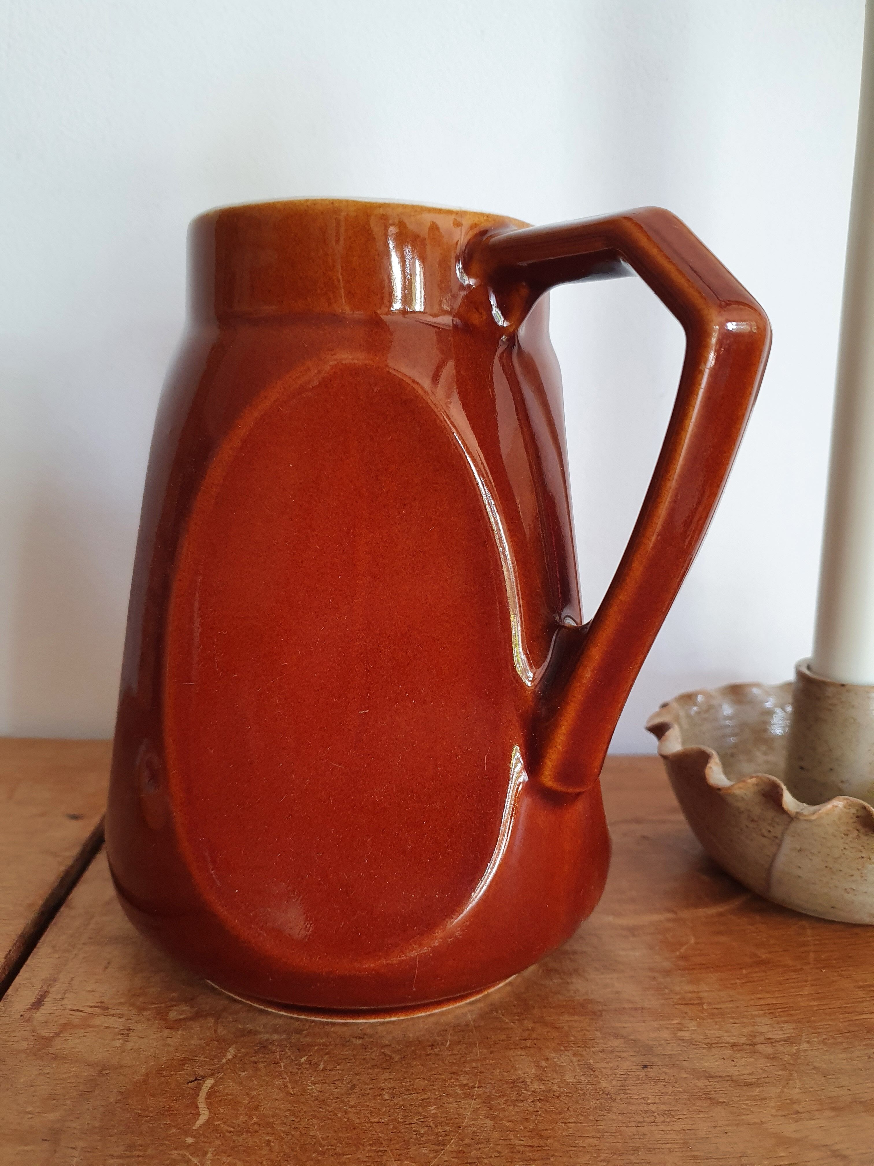 Pitcher in brown sandstone