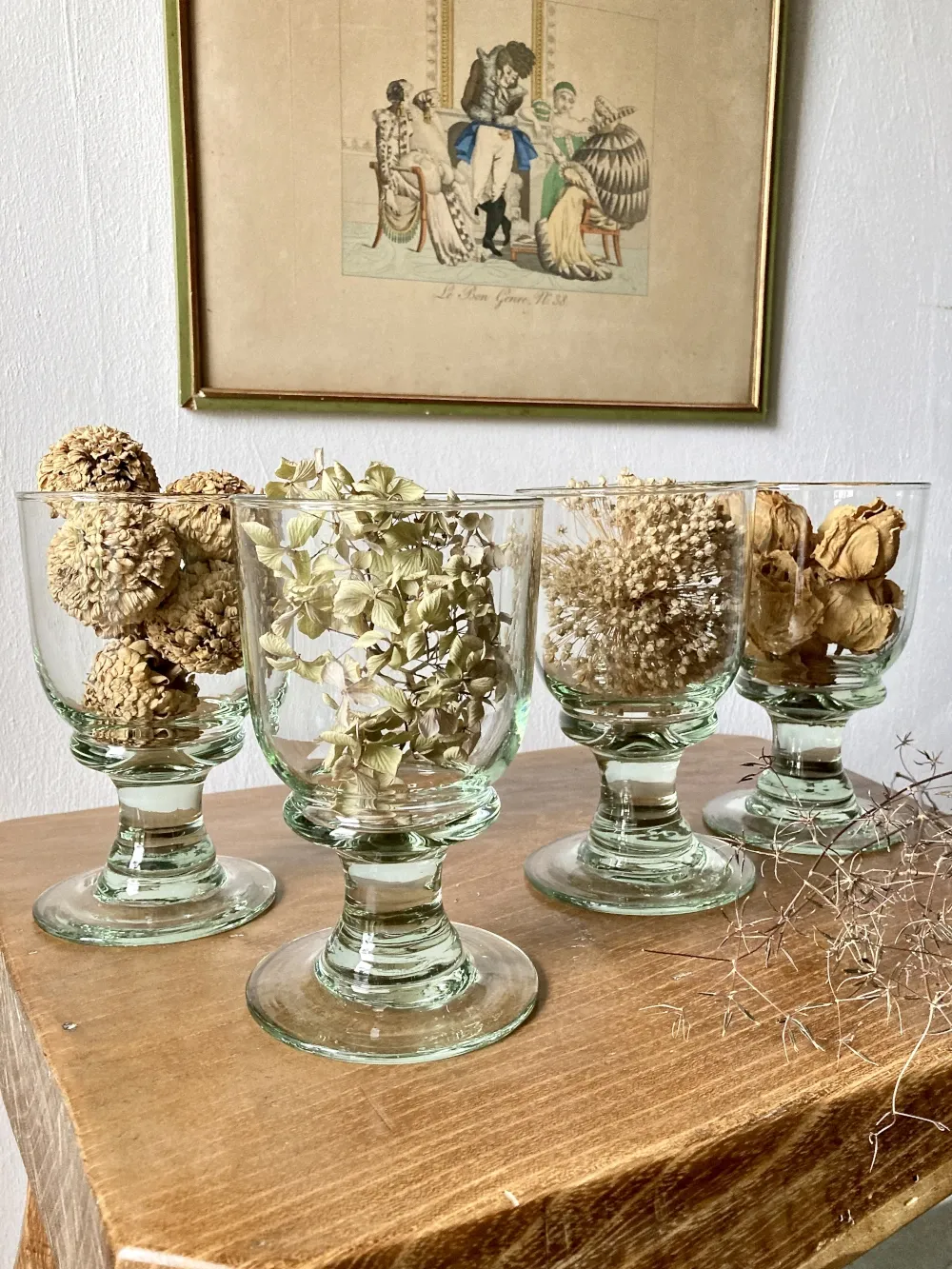 4 stemmed glasses made of handcrafted blown glass in green hue.