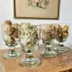 4 stemmed glasses made of handcrafted blown glass in green hue.