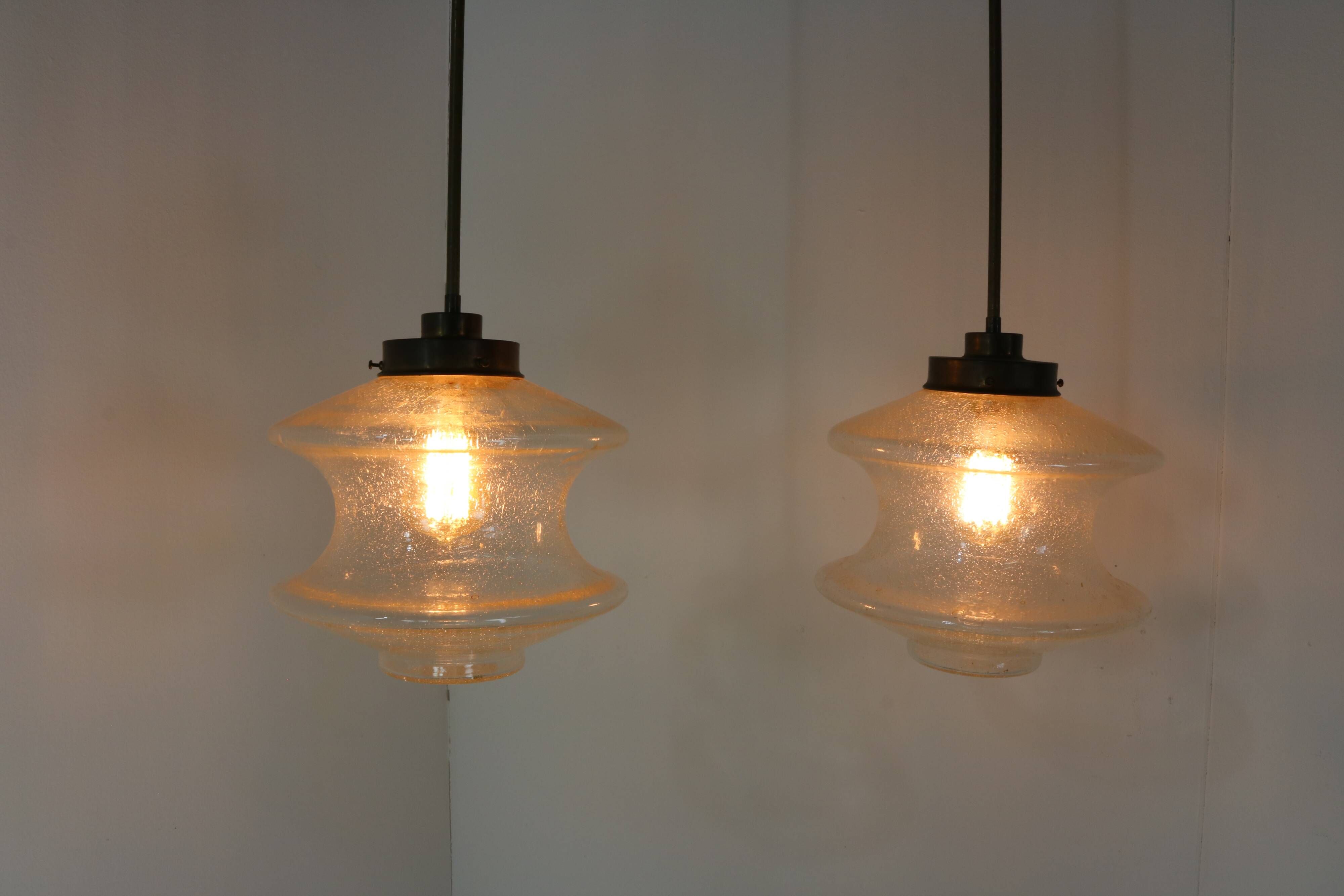 Set of two glass pendant lighting designed by Raak Holland