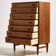 Restored teak chest of drawers with seven drawers.