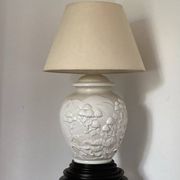 1980s ceramic table lamp with a wooden base and adjustable shade.