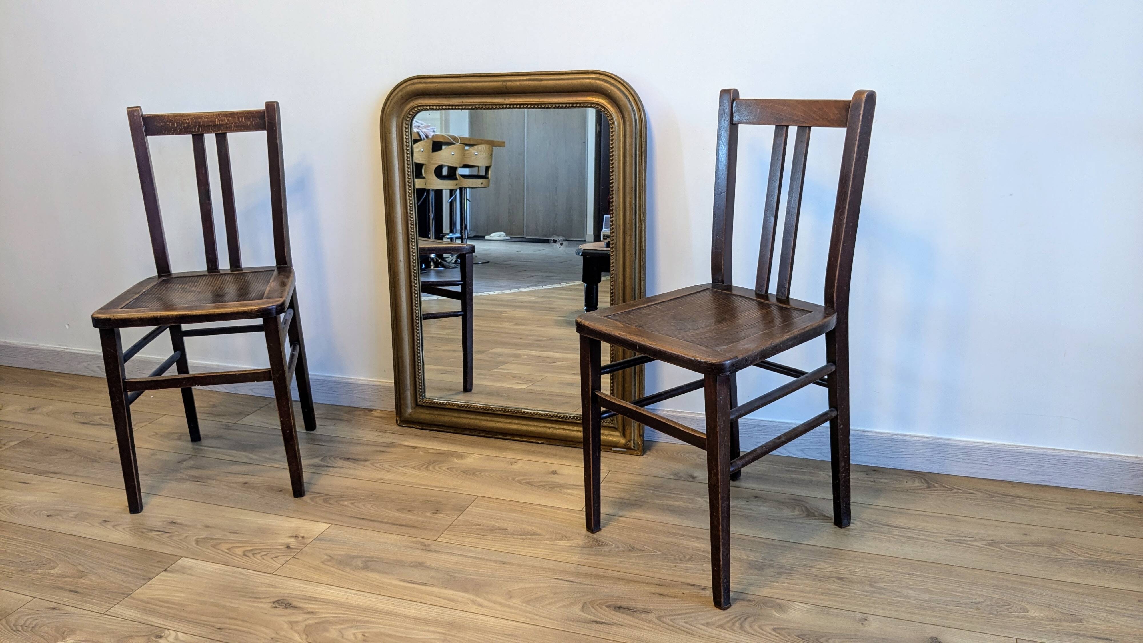 Pair of 1930s bistro chairs with patinated wood.