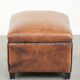Characterful sheepskin footstool/ottoman finished with black piping