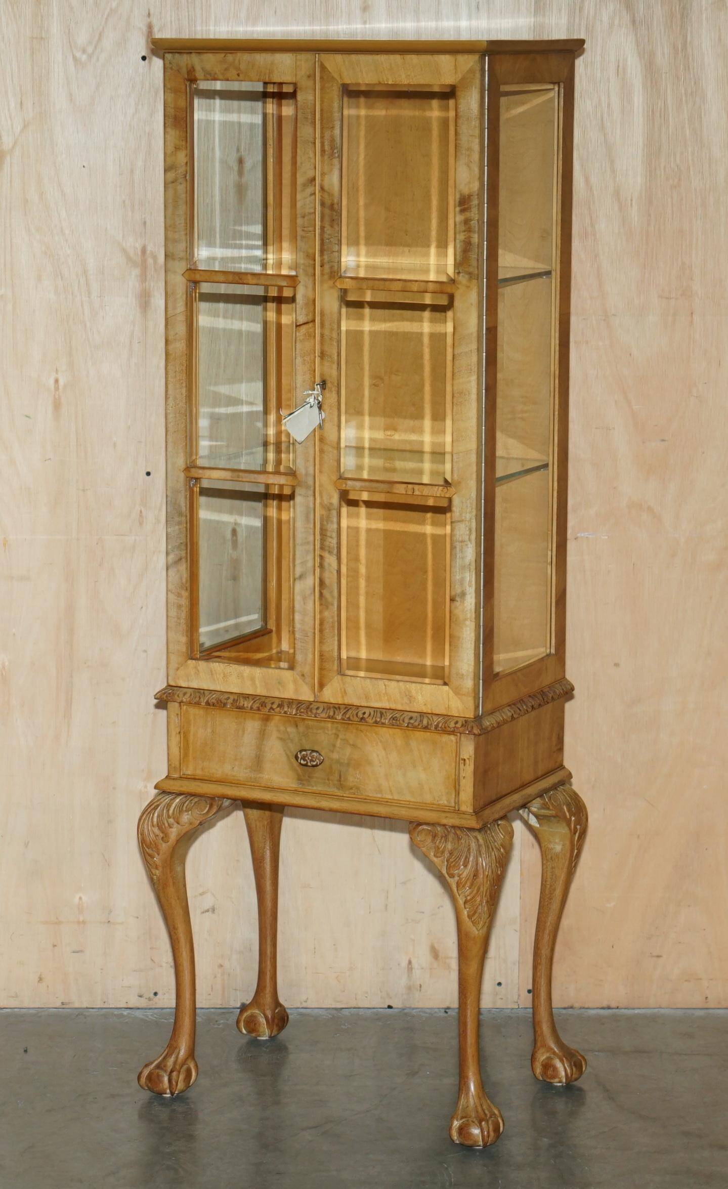 Pair of Art Deco display cabinets circa 1920 in light walnut with Cabriolet legs.
