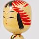 Decorative Kokeshi doll sculpture from northern Japan, hand-painted, signed.