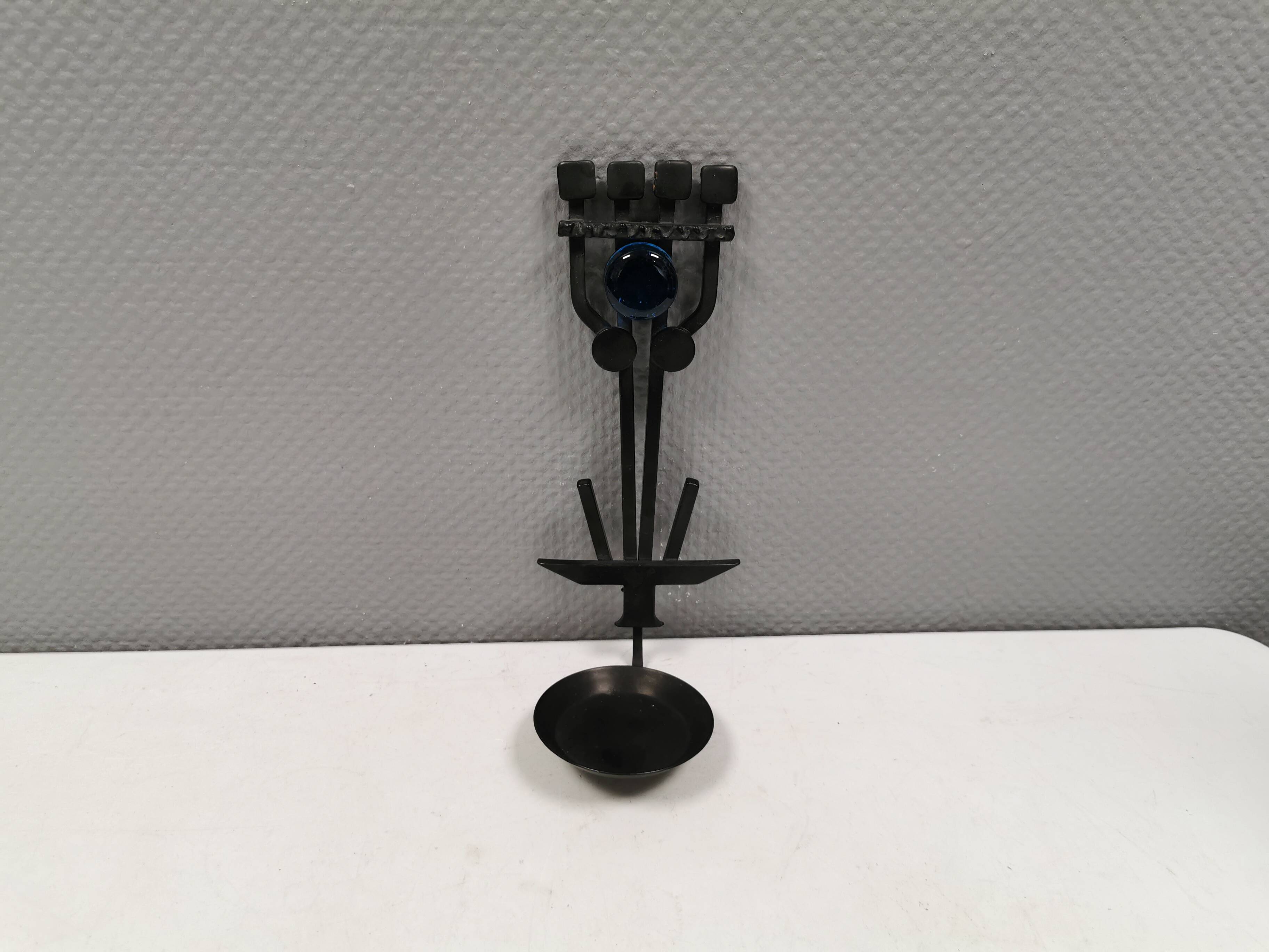 Vintage wall candle holder in wrought iron and hard pressed blue glass.