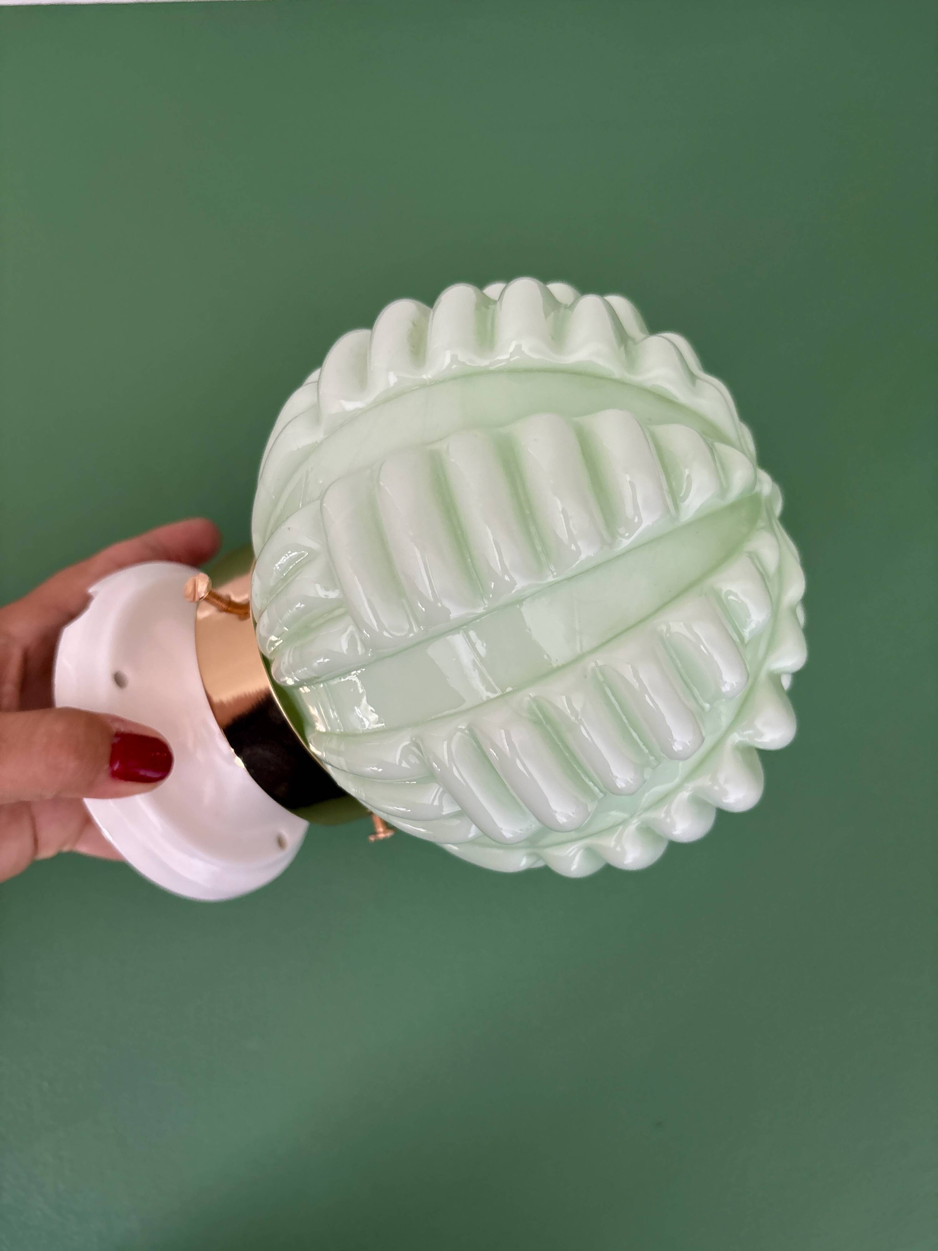 Vintage Art Deco globe wall light in pale green opaline.