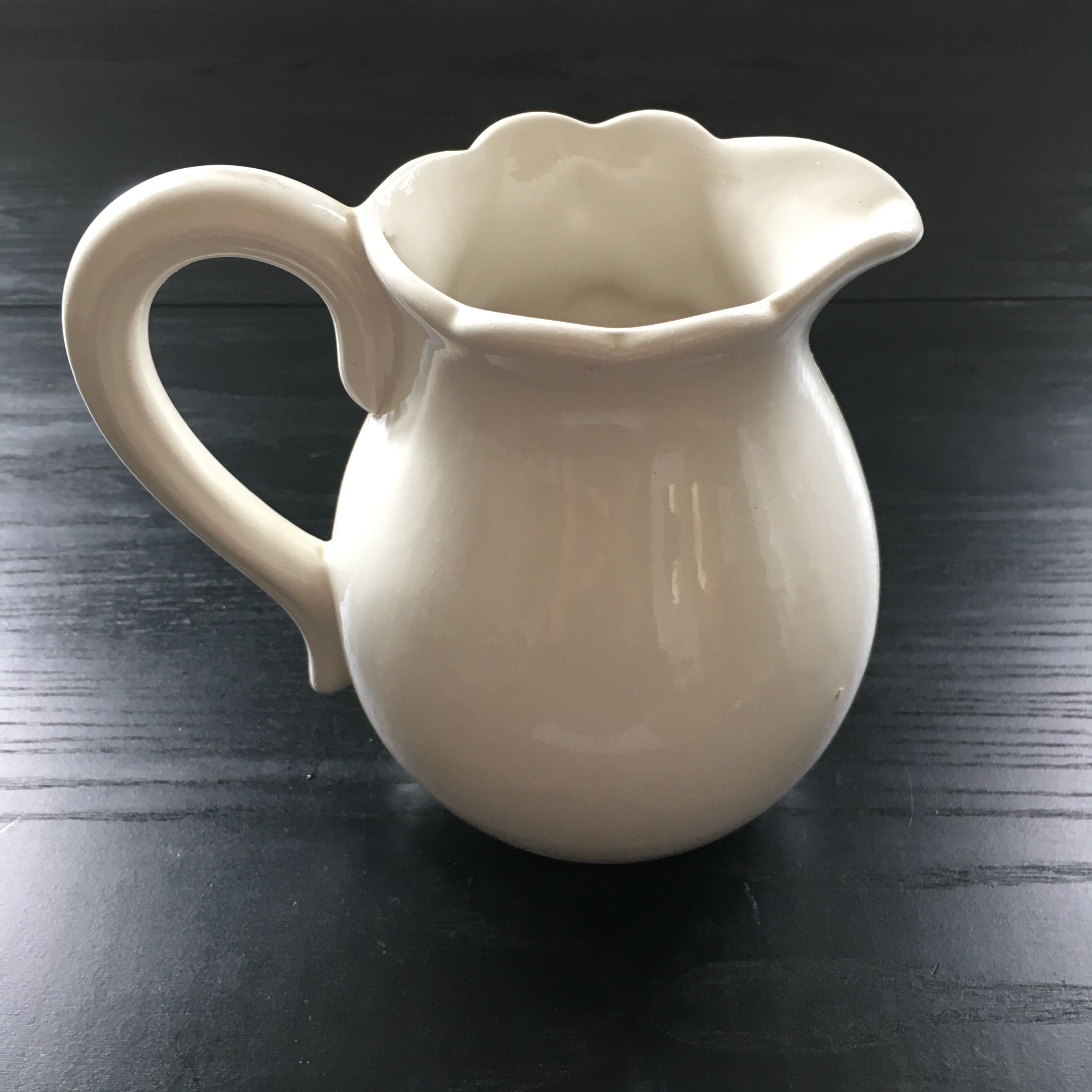 Fruit-decorated pitcher in slipware