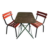 French antique folding bistro table with a pair of vintage garden chairs.