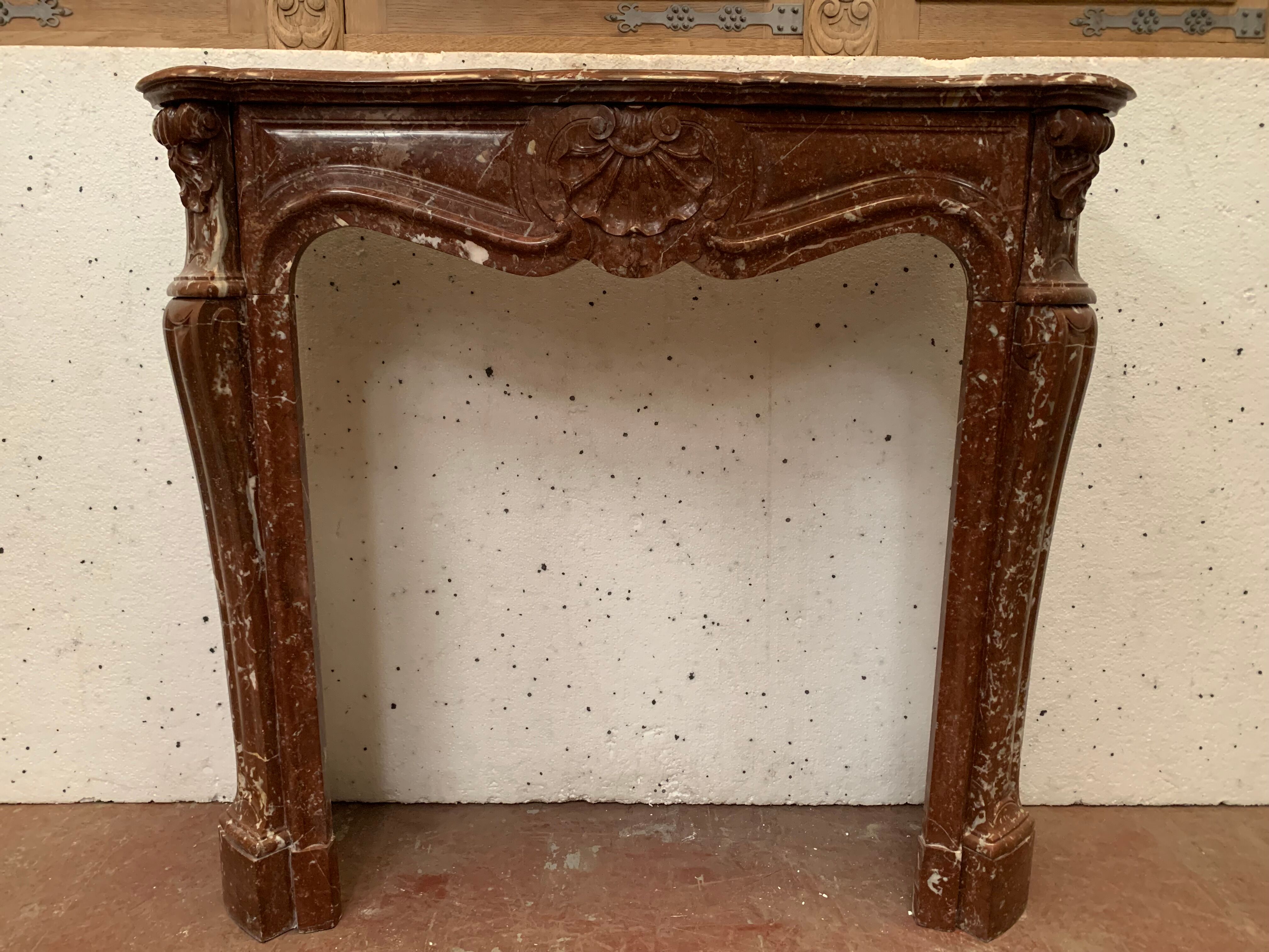 Fireplace three shells louis XV style in royal red marble XIX century