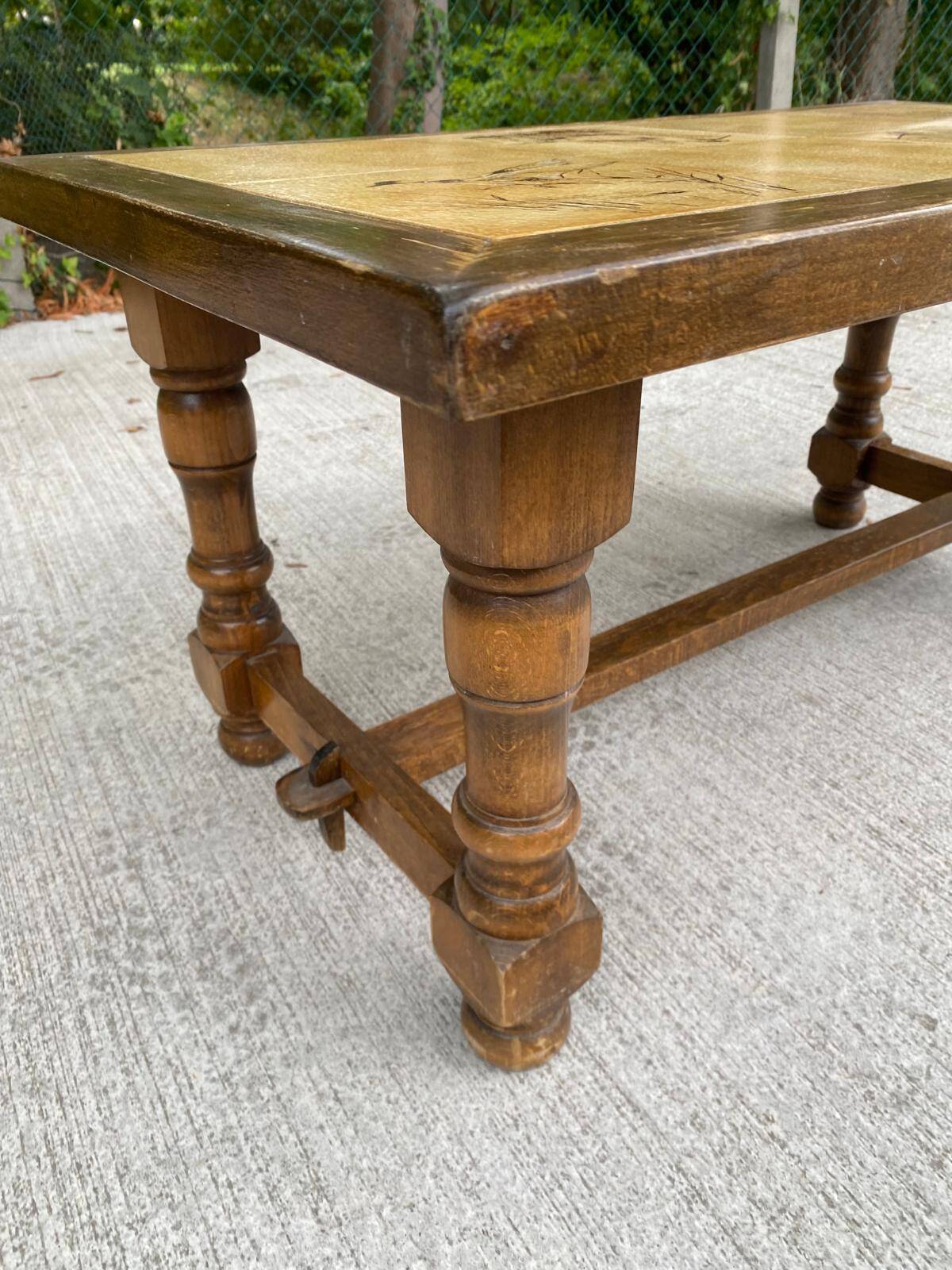 Vintage 70s coffee table with wood and ceramic tiles featuring bird and nature patterns.