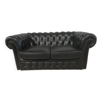 Two-seater black leather Chesterfield sofa